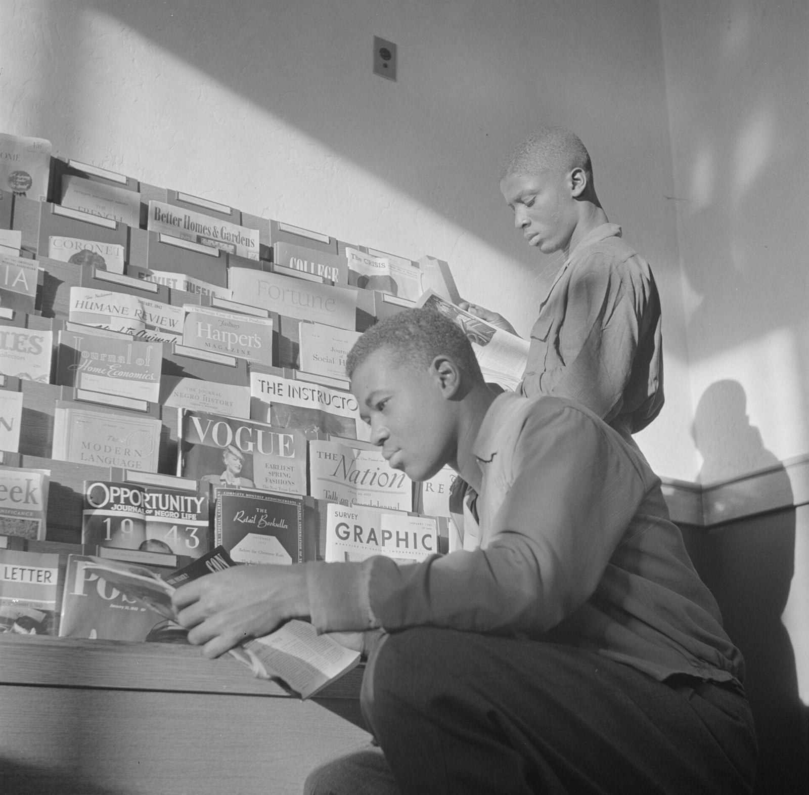 Students studying in a college library reading room